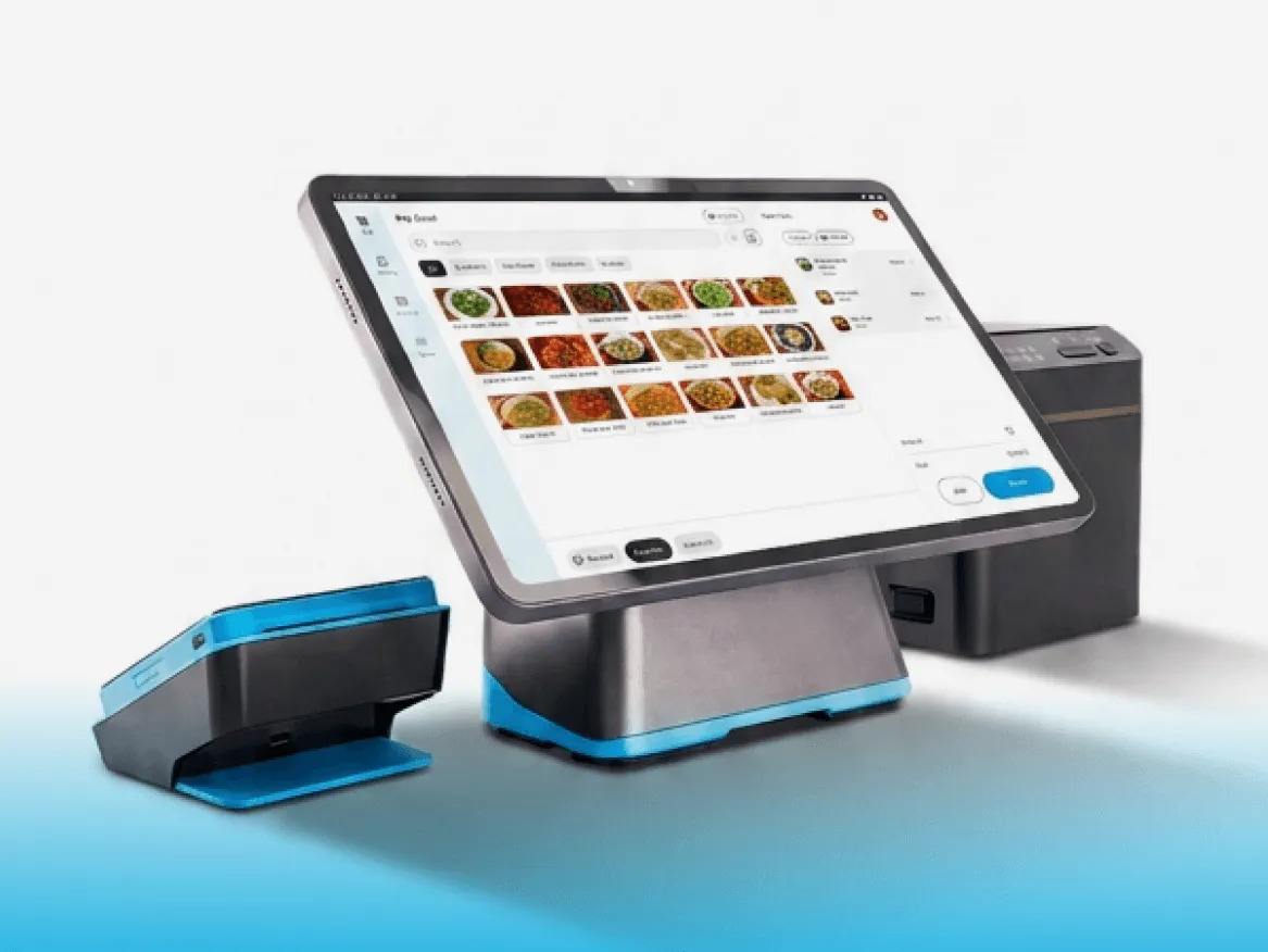 Countertop point-of-sale system displaying a restaurant menu, with a payment terminal and receipt printer.