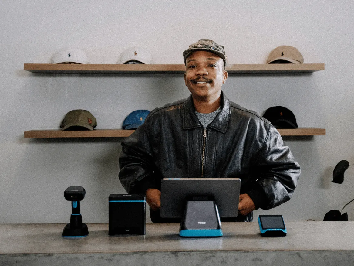 A store manager behind a modern point of sale system