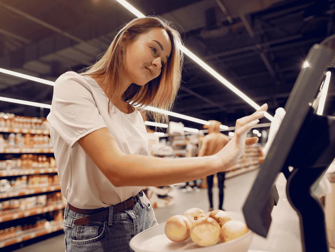 Shopper placing an order using a self-service touchscreen kiosk.