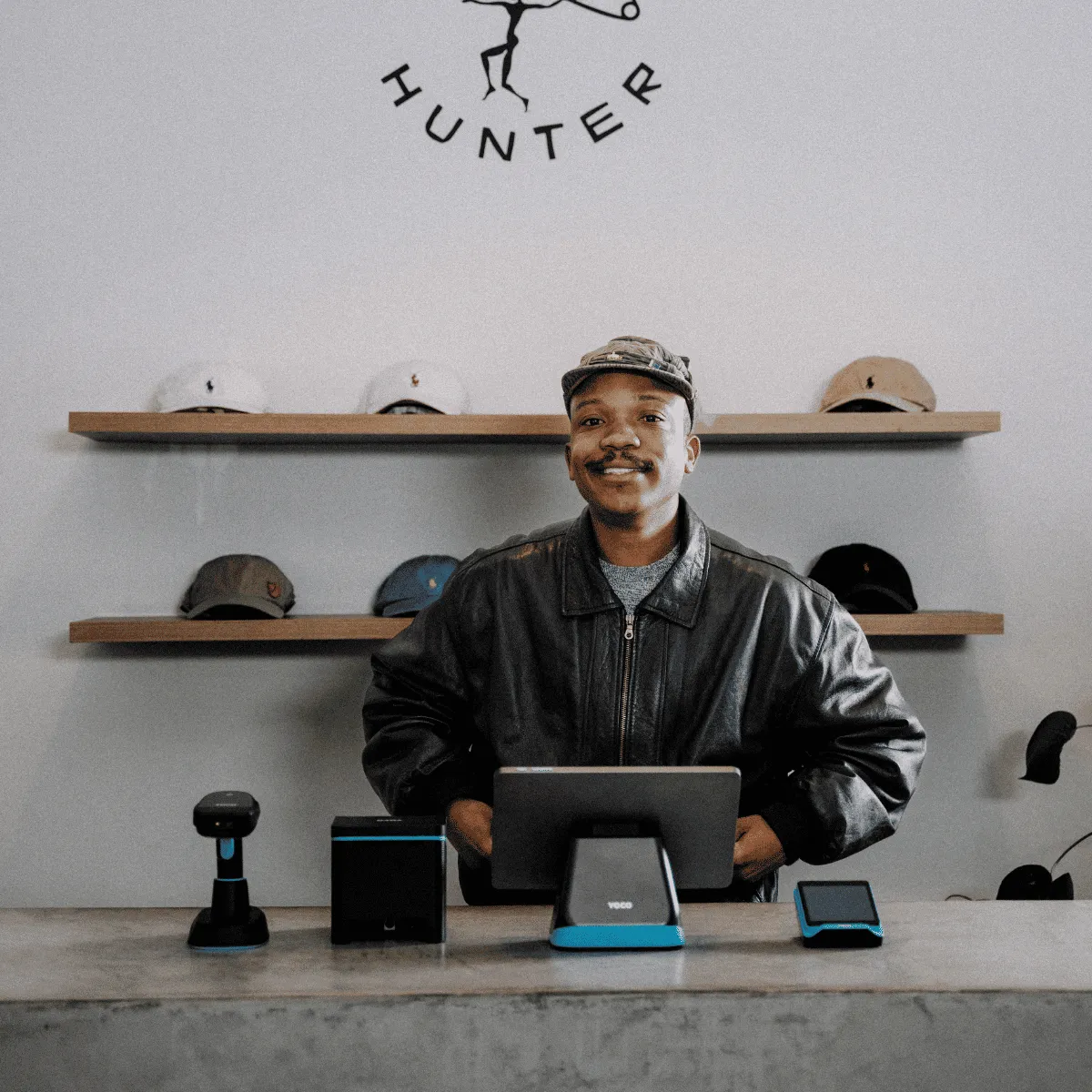 A store manager behind a modern point of sale system