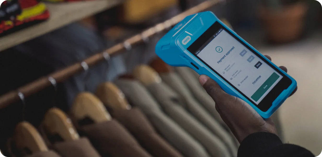 Retail store using the Yoco Khumo Print card machine to approve a payment.
