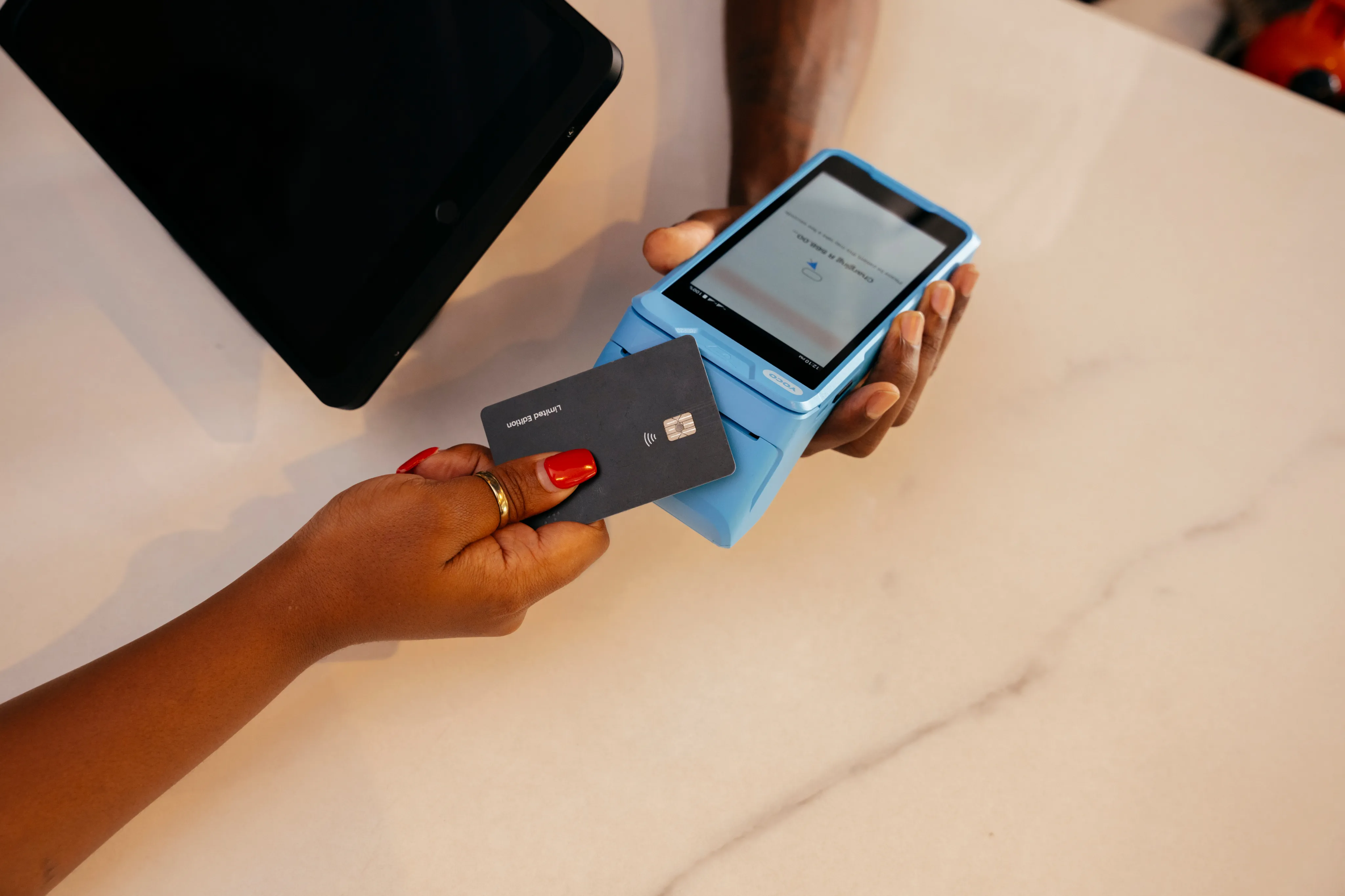 Customer making a payment with a Yoco Khumo Print card machine, which prints and sends digital receipts.