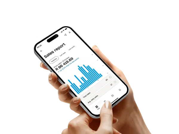 Hand holding a smartphone displaying a sales report with bar chart