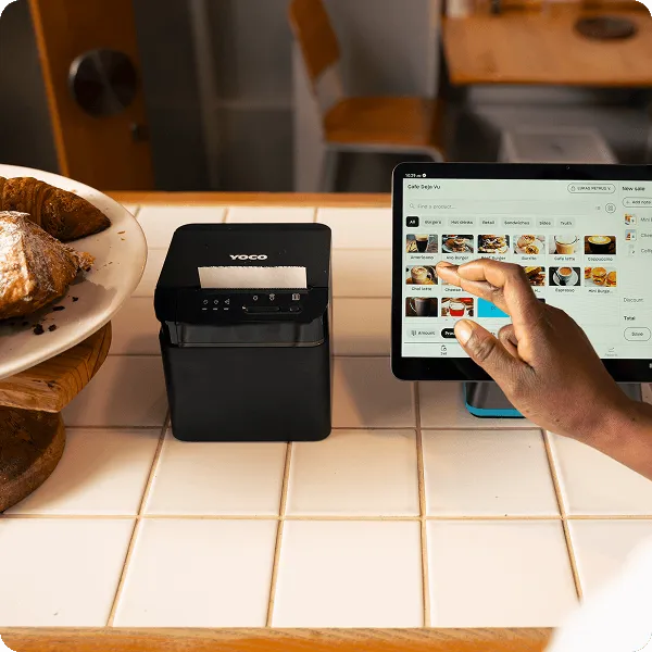 Close-up of a Yoco receipt printer ready for printing, part of the Yoco Counter point of sale setup.