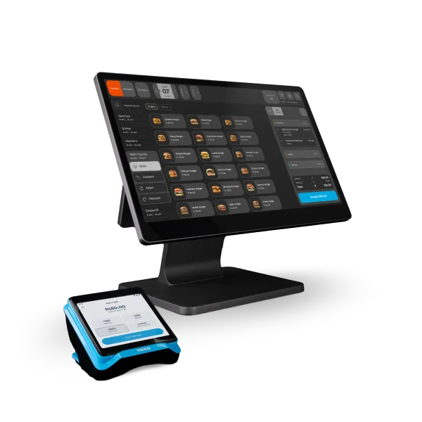 Table by Yoco POS system with touchscreen display and card machine, designed for restaurant order and payment management.