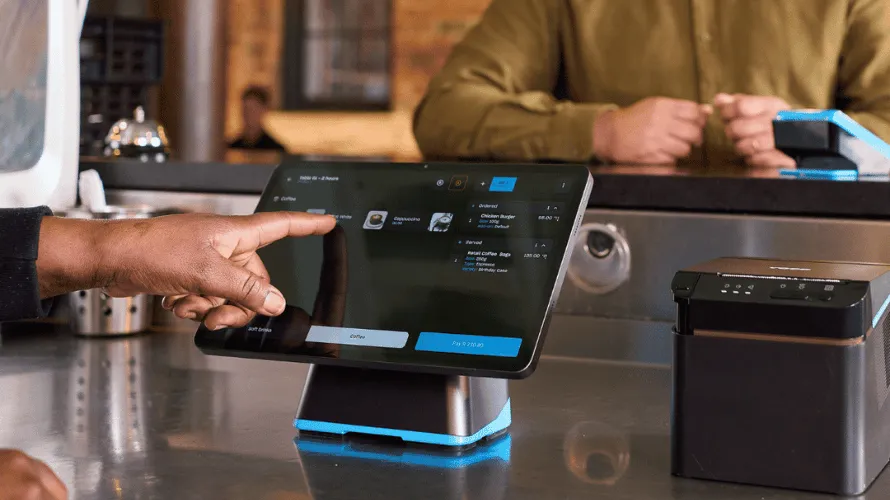 Staff taking a customers order and processing a payment