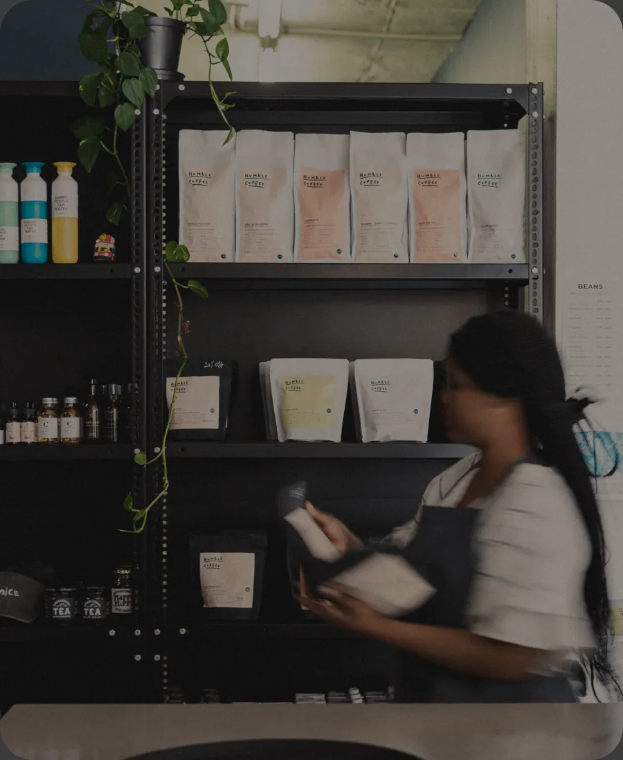 A staff member restocking shelves with fresh inventory.